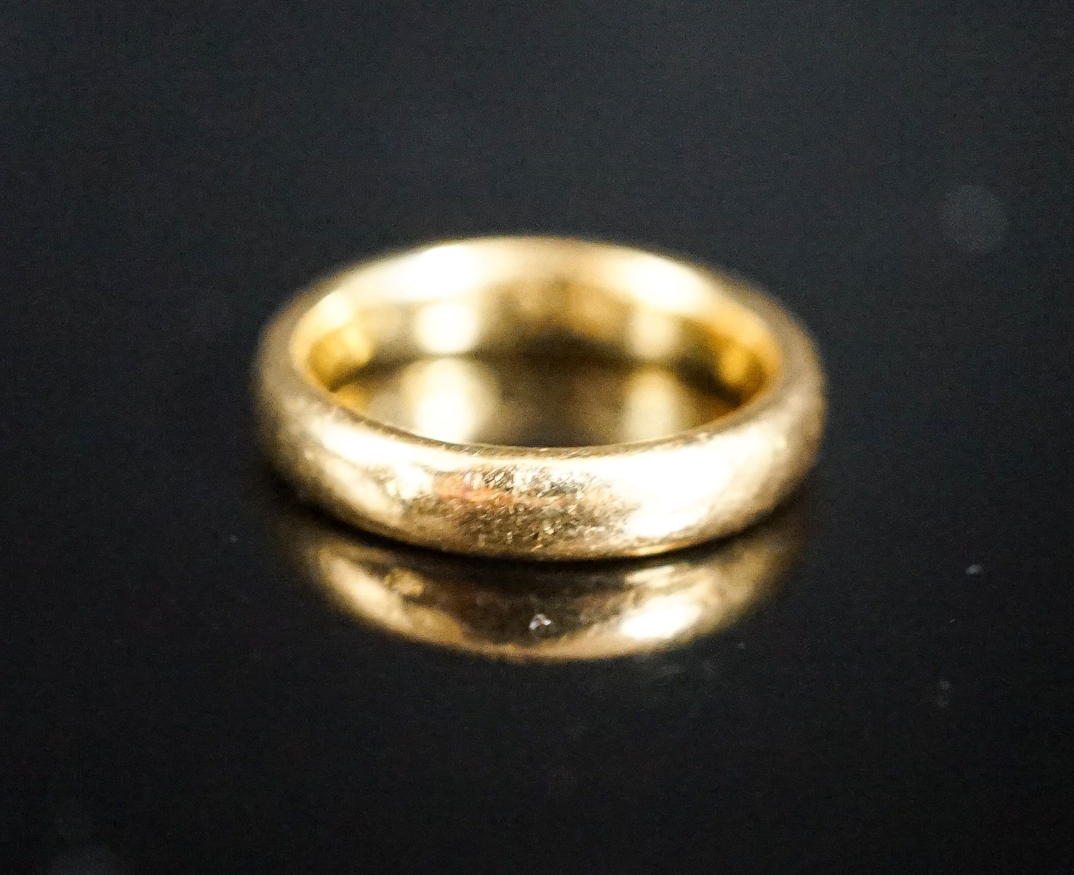 A 22ct. yellow gold wedding band, size L, 6.4 grams.